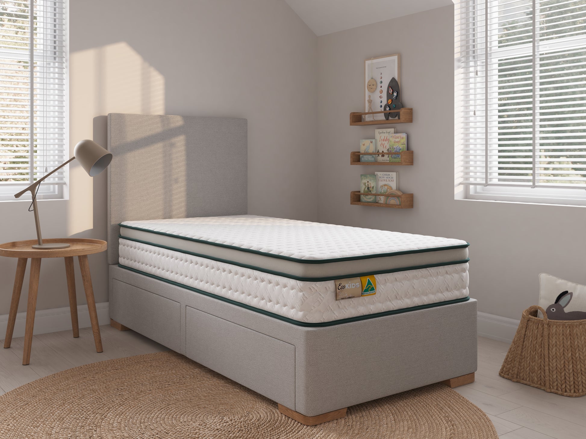 Mattress on a bed frame in a bedroom setting with decor elements.